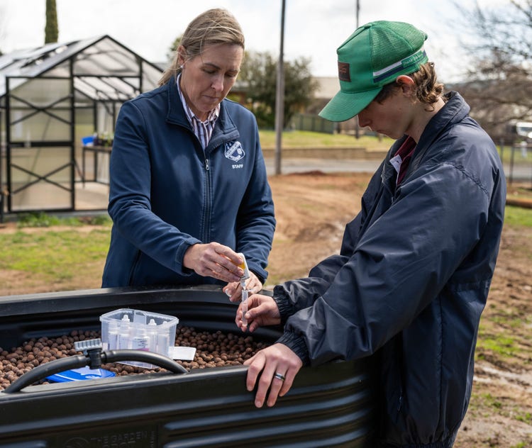 deputy and ag student soil testing
